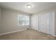 Cozy bedroom with neutral carpet, a window, and ample closet space at 174 Buena Vale Dr, Gastonia, NC 28056