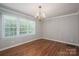 Light-filled dining room with hardwood floors and traditional chandelier at 174 Buena Vale Dr, Gastonia, NC 28056