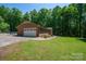 Lovely brick home featuring an attached garage and a sprawling front yard, surrounded by verdant trees at 174 Buena Vale Dr, Gastonia, NC 28056