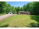Brick home with an attached garage and separate storage building on a spacious lot with mature trees at 174 Buena Vale Dr, Gastonia, NC 28056