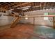 Spacious garage interior with high ceilings, exposed beams, and a loft area at 174 Buena Vale Dr, Gastonia, NC 28056
