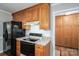 Kitchen with wood cabinets, black appliances, tile backsplash, offering a functional space for cooking and storage at 174 Buena Vale Dr, Gastonia, NC 28056