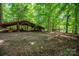 Exterior shot of an outbuilding in a heavily wooded area at 174 Buena Vale Dr, Gastonia, NC 28056