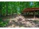 Outbuilding with wooden support beams offering open space in a wooded area, surrounded by greenery at 174 Buena Vale Dr, Gastonia, NC 28056
