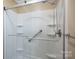 Close-up of a bright white shower with safety grab bars and built-in shelving at 174 Buena Vale Dr, Gastonia, NC 28056
