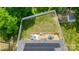 Aerial view of a fenced backyard with lush grass, a wooden deck with patio seating, and a solar panel roof at 208 N Kayla Dr, Salisbury, NC 28146