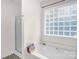 Bright bathroom with a shower, a bathtub, glass block window, and stylish flooring at 208 N Kayla Dr, Salisbury, NC 28146