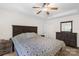 A Primary bedroom featuring a ceiling fan, a wooden dresser, and hardwood floors with a large cozy bed at 208 N Kayla Dr, Salisbury, NC 28146