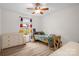 Bright bedroom features a ceiling fan, wood-look flooring, and a sunny window at 208 N Kayla Dr, Salisbury, NC 28146