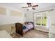 Bright bedroom features wood-look flooring, a ceiling fan, and a large sunny window at 208 N Kayla Dr, Salisbury, NC 28146