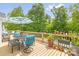 A beautifully furnished deck with table, chairs, umbrella, and potted plants, perfect for outdoor relaxation at 208 N Kayla Dr, Salisbury, NC 28146