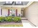 Charming front porch with seating, colorful shutters, a decorative door wreath, and landscaped garden at 208 N Kayla Dr, Salisbury, NC 28146
