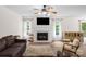 Bright living room with a fireplace, ceiling fan, and natural light at 208 N Kayla Dr, Salisbury, NC 28146