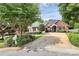 Classic brick home with manicured landscaping, mature trees, and a spacious driveway leading to a two-car garage at 2289 Veery Ln, Rock Hill, SC 29732