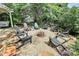 Cozy backyard fire pit area with Adirondack chairs and beautiful landscaping at 2289 Veery Ln, Rock Hill, SC 29732