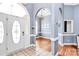 Elegant foyer with arched doorways, hardwood floors, and a chandelier, leading into a naturally lit dining area at 2289 Veery Ln, Rock Hill, SC 29732
