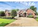 Charming red brick home featuring a well-manicured front yard and a two-car garage with a concrete driveway at 2289 Veery Ln, Rock Hill, SC 29732