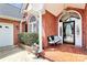 Charming covered front porch with a comfortable bench, decorative plants, and a beautiful arched front door at 2289 Veery Ln, Rock Hill, SC 29732