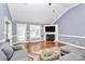 Inviting living room featuring hardwood floors, a cozy fireplace, and large windows that fill the room with light at 2289 Veery Ln, Rock Hill, SC 29732