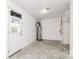 Utility room in the basement, featuring a door to the yard, water heater, and other appliances at 2635 Mccurdy Trl, Charlotte, NC 28269