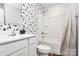Contemporary bathroom with modern fixtures, black and white spotted accent wall, and shower at 2635 Mccurdy Trl, Charlotte, NC 28269