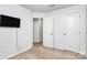 Simple bedroom with white walls, carpet, TV and two doors at 2635 Mccurdy Trl, Charlotte, NC 28269
