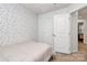 Comfortable bedroom featuring stylish wallpaper, neutral carpet, and ample closet space at 2635 Mccurdy Trl, Charlotte, NC 28269