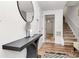 Bright entryway featuring hardwood floors, stairs, a modern console table and round mirror at 2635 Mccurdy Trl, Charlotte, NC 28269