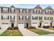 Attractive townhomes featuring a blend of neutral siding colors, shutters, and attached single-car garages at 2635 Mccurdy Trl, Charlotte, NC 28269