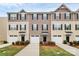 Charming townhome with well-manicured lawn, attached garages, and traditional architectural details at 2635 Mccurdy Trl, Charlotte, NC 28269