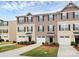 Townhouses with well kept lawns and garages, with a beige and brown color scheme at 2635 Mccurdy Trl, Charlotte, NC 28269