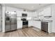 Modern kitchen featuring stainless steel appliances, white cabinetry, and wood flooring at 2635 Mccurdy Trl, Charlotte, NC 28269