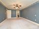 Bedroom featuring patterned wallpaper, carpet, and access to a bathroom at 2919 Peachwood Ct, Fort Mill, SC 29715