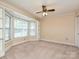 Cozy bedroom featuring a bay window with built-in shelves and neutral carpeting at 2919 Peachwood Ct, Fort Mill, SC 29715