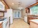 Traditional kitchen features wooden cabinets, white appliances, and sliding glass doors at 2919 Peachwood Ct, Fort Mill, SC 29715