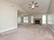 Bright living room with vaulted ceiling, ceiling fan, stone fireplace and large windows at 2919 Peachwood Ct, Fort Mill, SC 29715