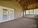 Covered porch featuring exposed wood beam ceiling, fan, and access to the backyard at 2919 Peachwood Ct, Fort Mill, SC 29715