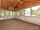Charming screened-in porch with exposed wood beams, fan, and ample natural light at 2919 Peachwood Ct, Fort Mill, SC 29715
