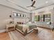 Comfortable bedroom featuring neutral colors, a large window seat, and tray ceilings with a ceiling fan at 2954 Holbrook Rd, Fort Mill, SC 29715