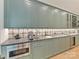 Charming butler pantry featuring custom cabinets, a wet bar, microwave, and decorative tile backsplash at 2954 Holbrook Rd, Fort Mill, SC 29715