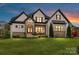 Stunning two-story home featuring stone accents, dark shutters, and a manicured lawn at 2954 Holbrook Rd, Fort Mill, SC 29715