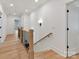 A well-lit hallway with hardwood floors and white walls leads to multiple rooms at 2954 Holbrook Rd, Fort Mill, SC 29715