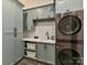 Well-organized laundry room with modern washer and dryer, custom cabinets, and ample counter space at 2954 Holbrook Rd, Fort Mill, SC 29715