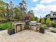 Well-equipped outdoor kitchen with stone countertops, a grill, a refrigerator, and ample space for food preparation at 2954 Holbrook Rd, Fort Mill, SC 29715
