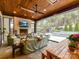 Inviting outdoor living space featuring a fireplace, comfortable seating, and access to a pool and lush landscaping at 2954 Holbrook Rd, Fort Mill, SC 29715