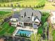 Aerial view of backyard with pool, patio, outdoor dining, and green landscaped yard at 2954 Holbrook Rd, Fort Mill, SC 29715