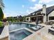 Stunning swimming pool and spa with a spacious patio, comfortable lounge chairs, and a beautiful backyard at 2954 Holbrook Rd, Fort Mill, SC 29715
