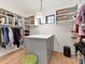 Walk-in closet includes custom shelving, an island for storage, and natural light from a window at 2954 Holbrook Rd, Fort Mill, SC 29715