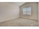 Cozy bedroom with neutral carpeting, a window providing natural light, and a vaulted ceiling at 3662 Charles Nw St, Conover, NC 28613