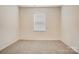 Bedroom features neutral carpeting, a window providing natural light, and neutral walls at 3662 Charles Nw St, Conover, NC 28613